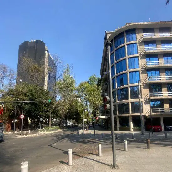 Street view of Polanco district in Mexico City, showing modern glass office buildings and quiet morning traffic near Surrogacy Mexico offices
