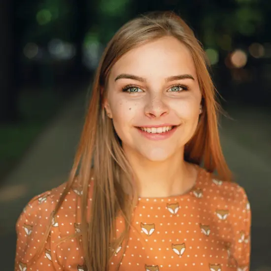Portrait of an international egg donor, smiling outdoors, used to illustrate global donor availability