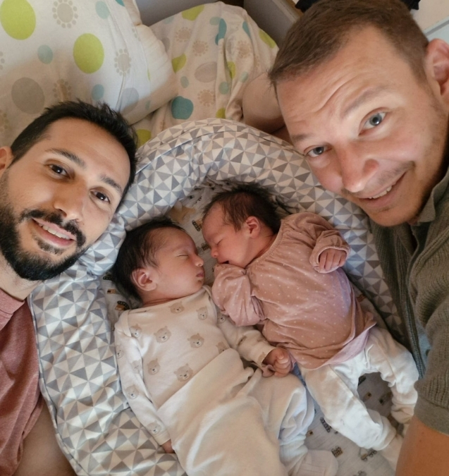 Two fathers with their newborn twin babies
